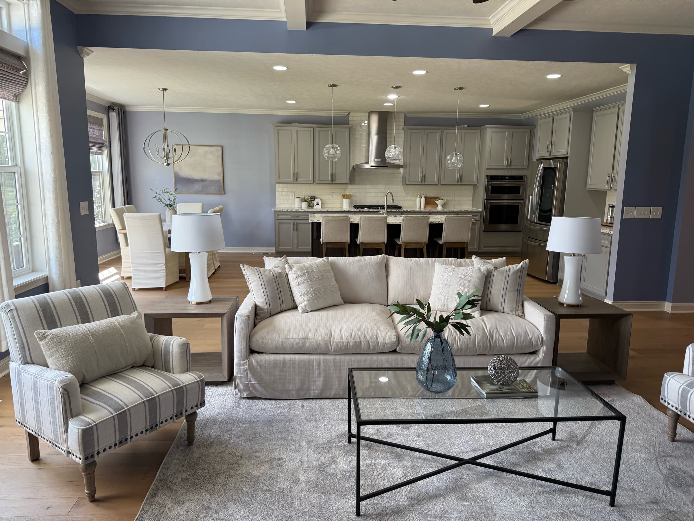 Staged open-concept living room furnished with substantial, well-scaled inventory pieces