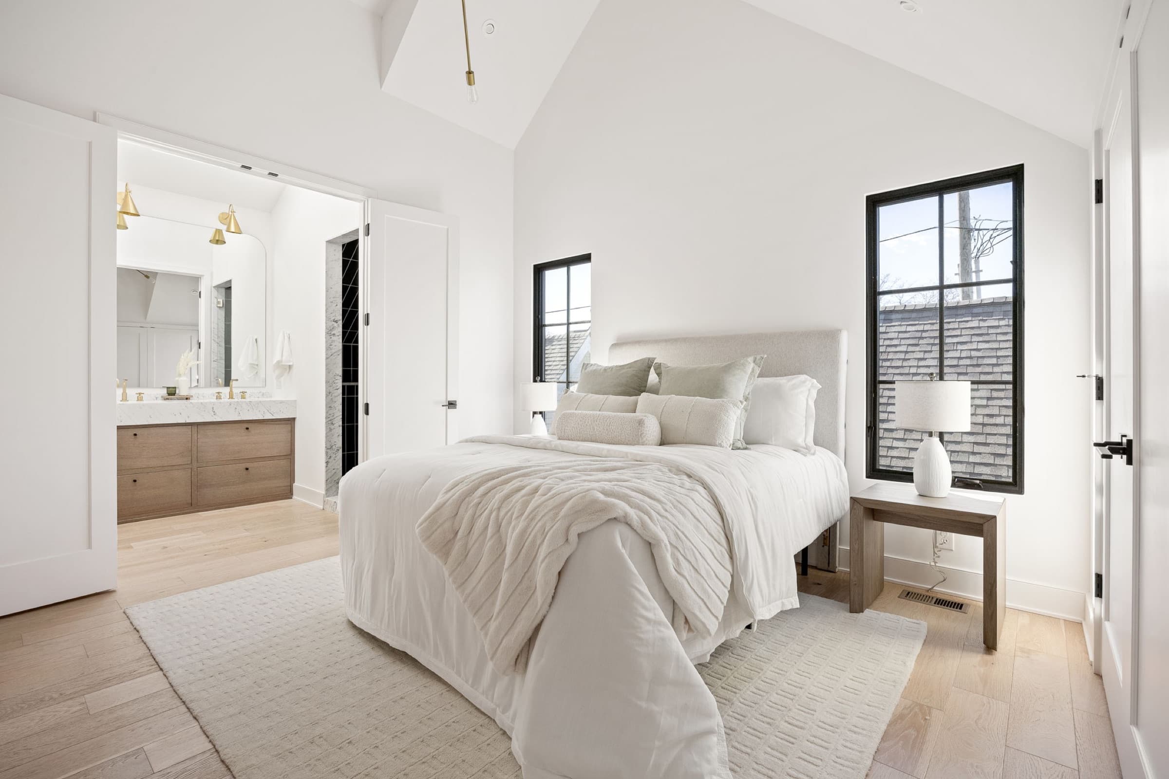 Staged bedroom with upholstered headboard and soft linens