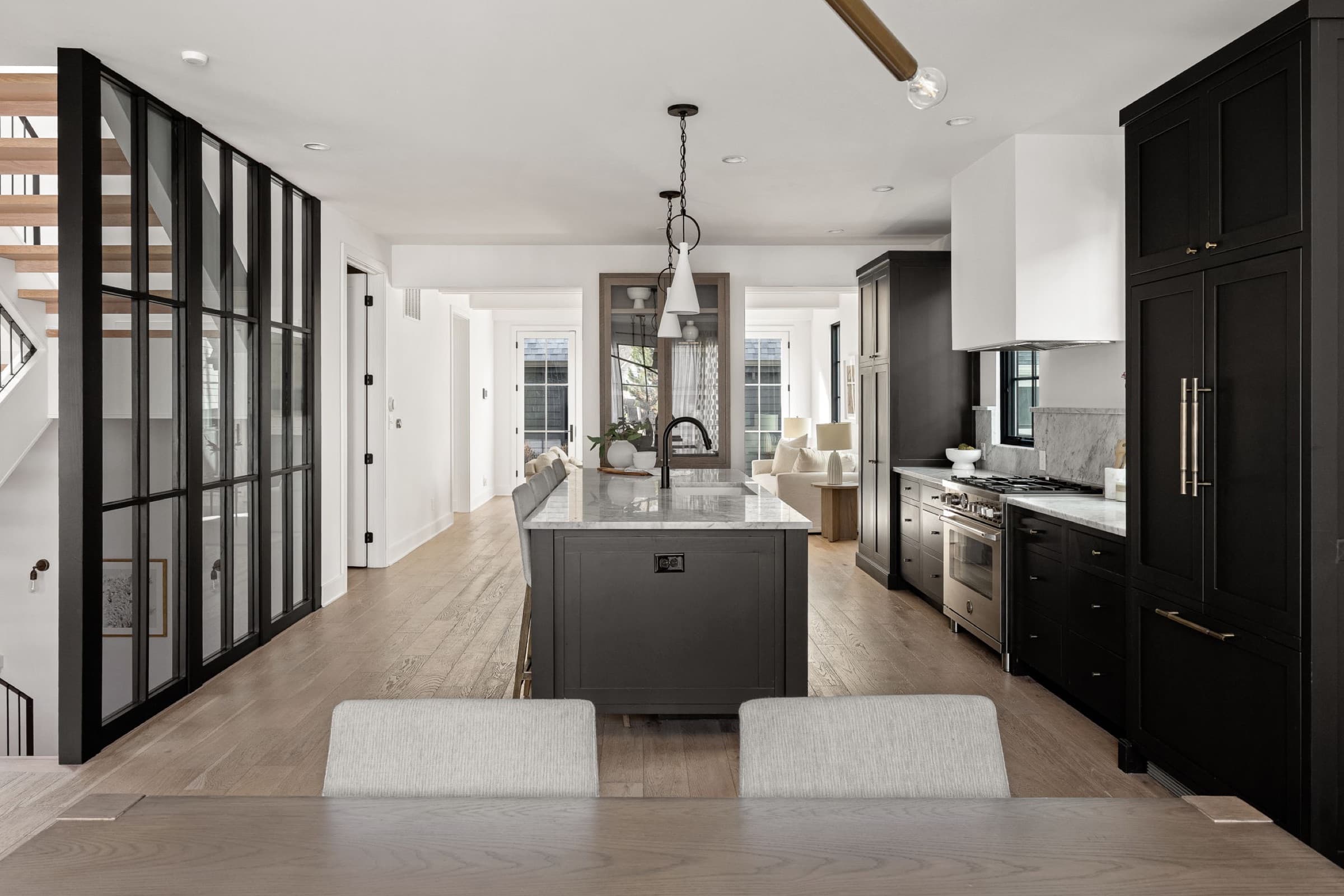 Staged kitchen with dark island and styled counter